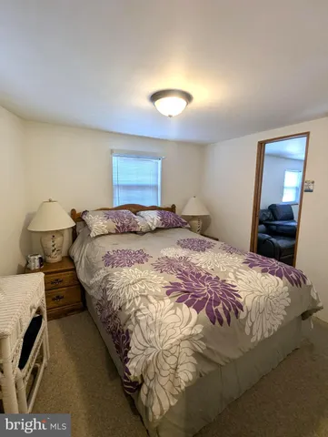 a bedroom with a bed and a lamp