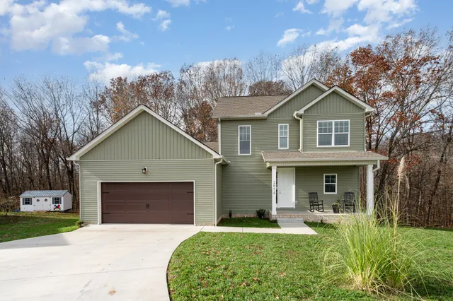 a front view of a house with a yard and garage