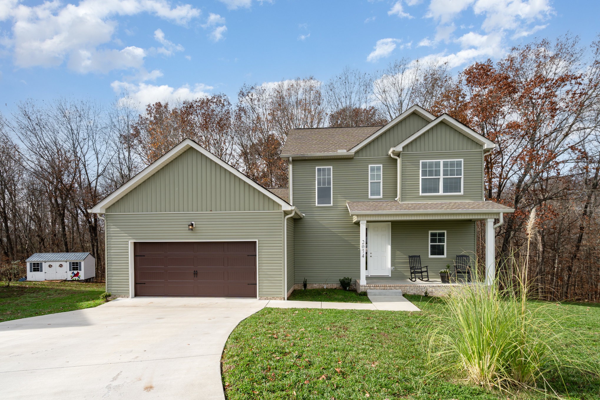 a front view of a house with a yard and garage