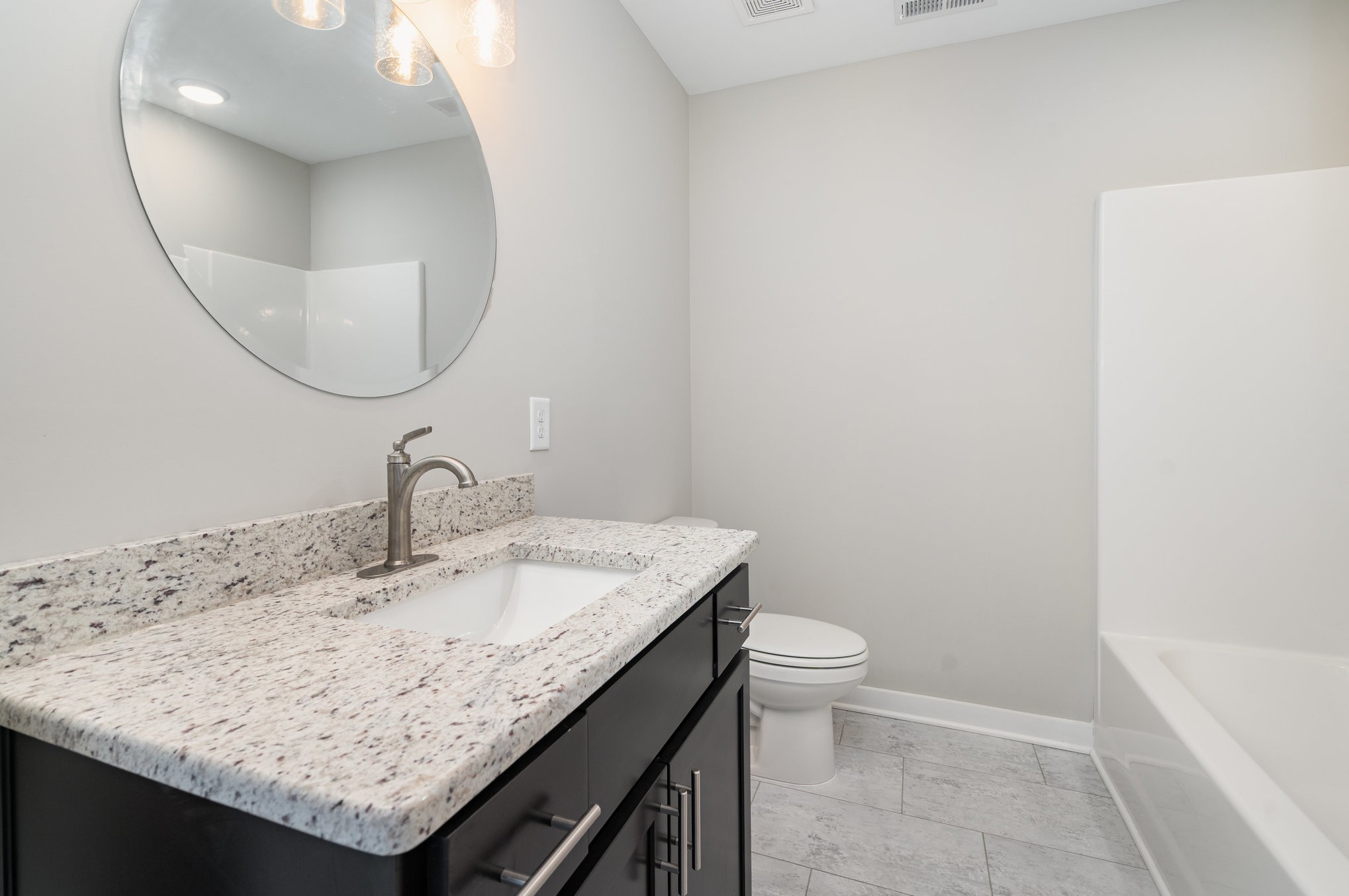 2074 Morgan Court Springfield, TN 37172 - Photo 18 of 24 a bathroom with a granite countertop sink a toilet and a mirror