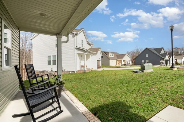 a view of a house with backyard and sitting area