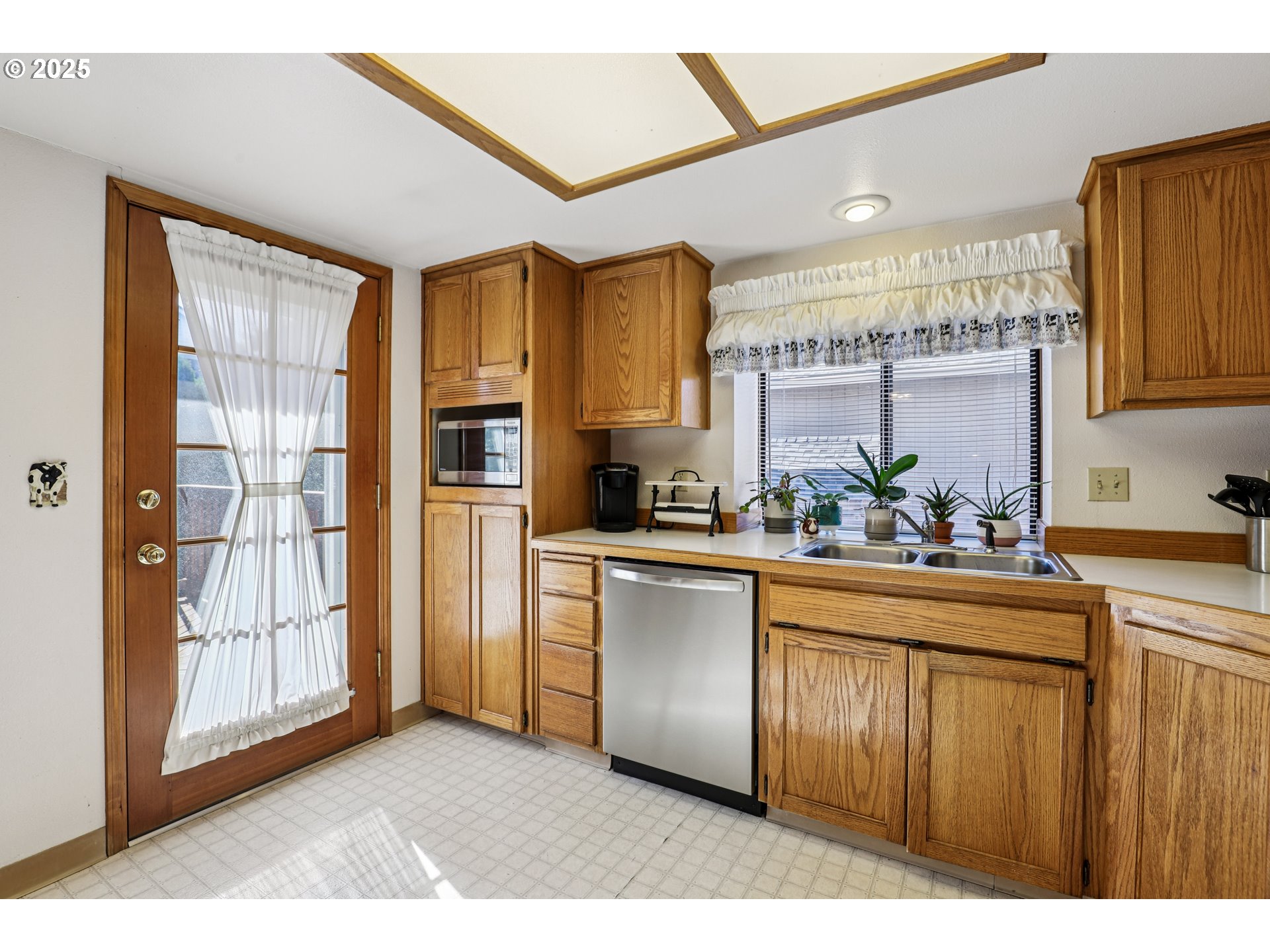 3786 Southwest 8th Street Gresham, OR 97030 - Photo 12 of 43 a kitchen with stainless steel appliances granite countertop a refrigerator and a sink
