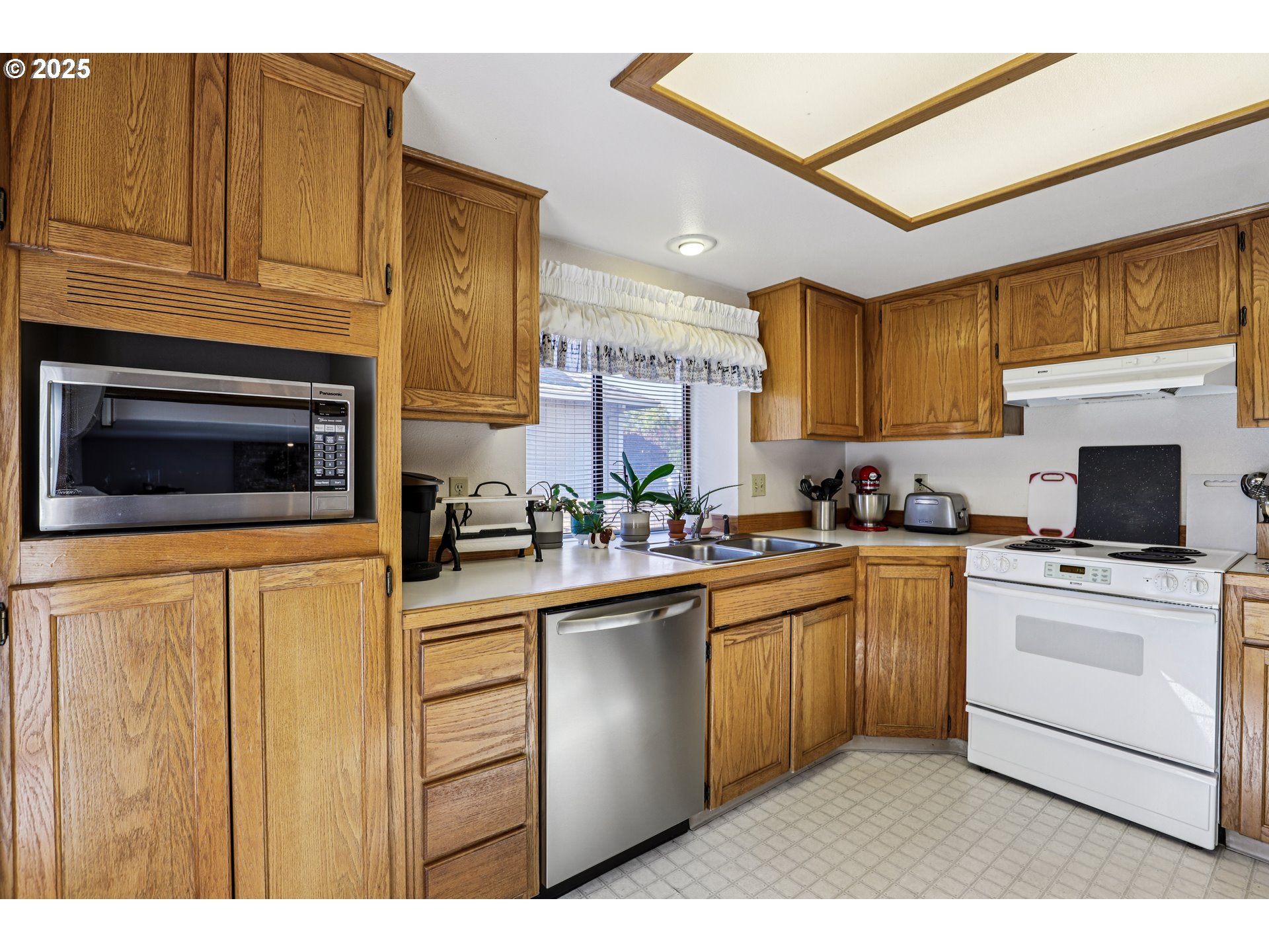 3786 Southwest 8th Street Gresham, OR 97030 - Photo 14 of 43 a kitchen with cabinets stainless steel appliances and a counter