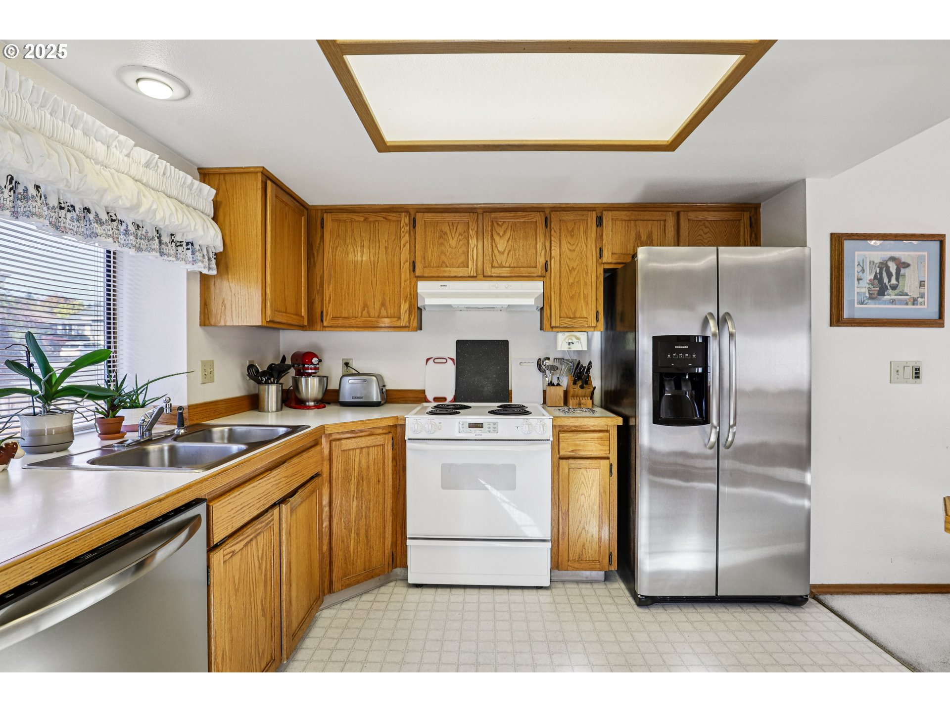 3786 Southwest 8th Street Gresham, OR 97030 - Photo 15 of 43 a kitchen with a refrigerator sink and stove