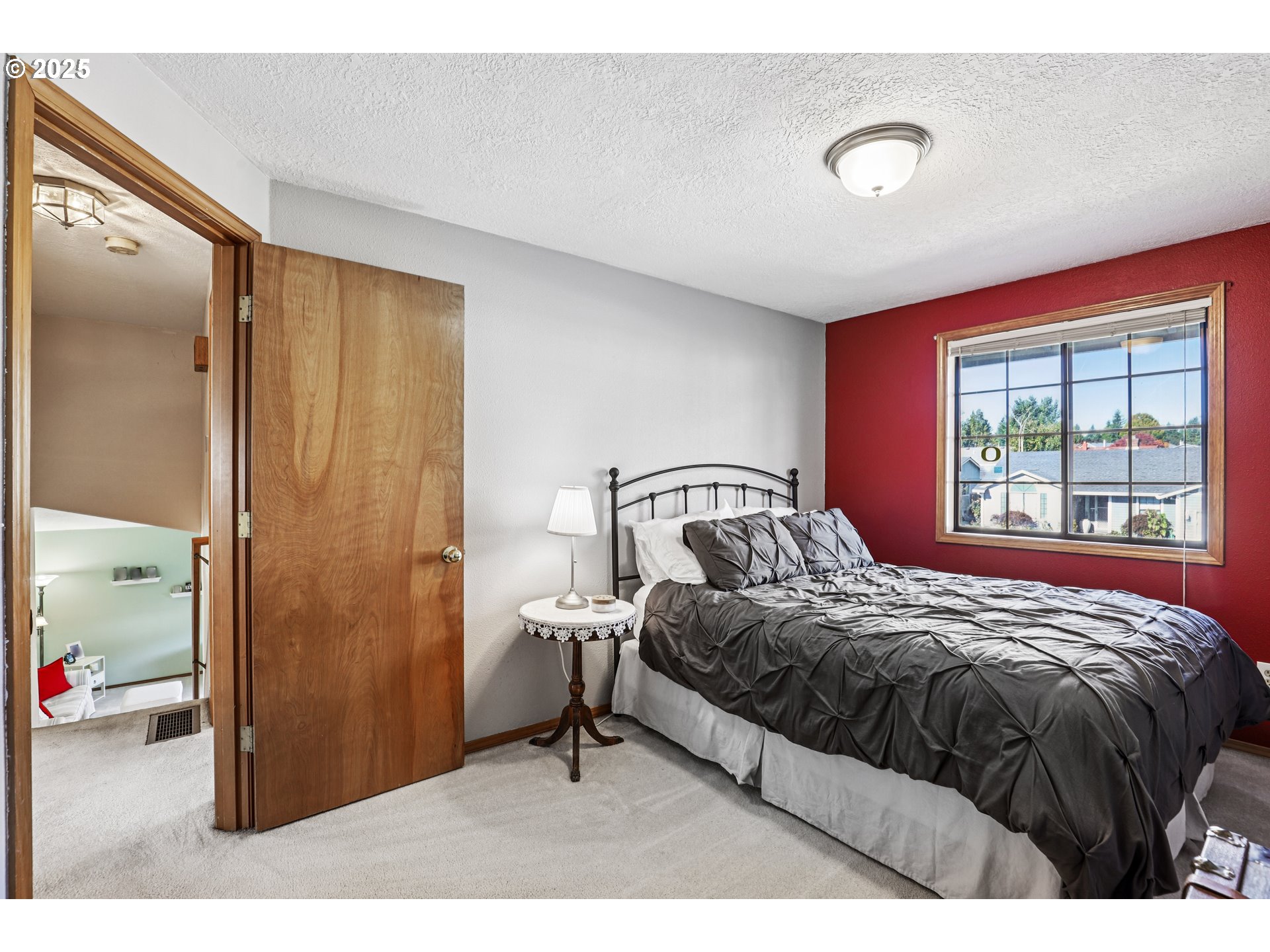 3786 Southwest 8th Street Gresham, OR 97030 - Photo 24 of 43 a bed sitting in a bedroom next to a window