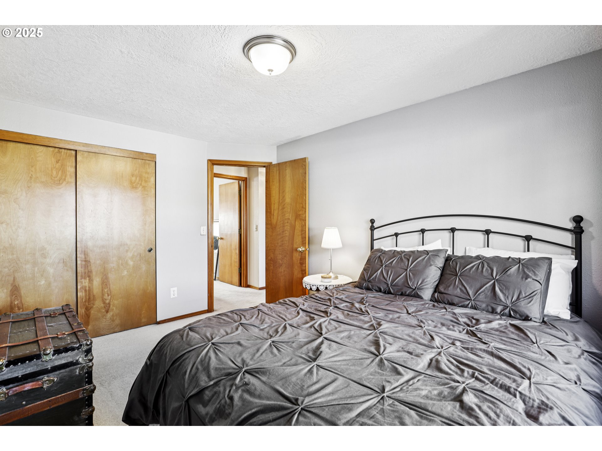 3786 Southwest 8th Street Gresham, OR 97030 - Photo 25 of 43 a bedroom with a large bed and a chandelier