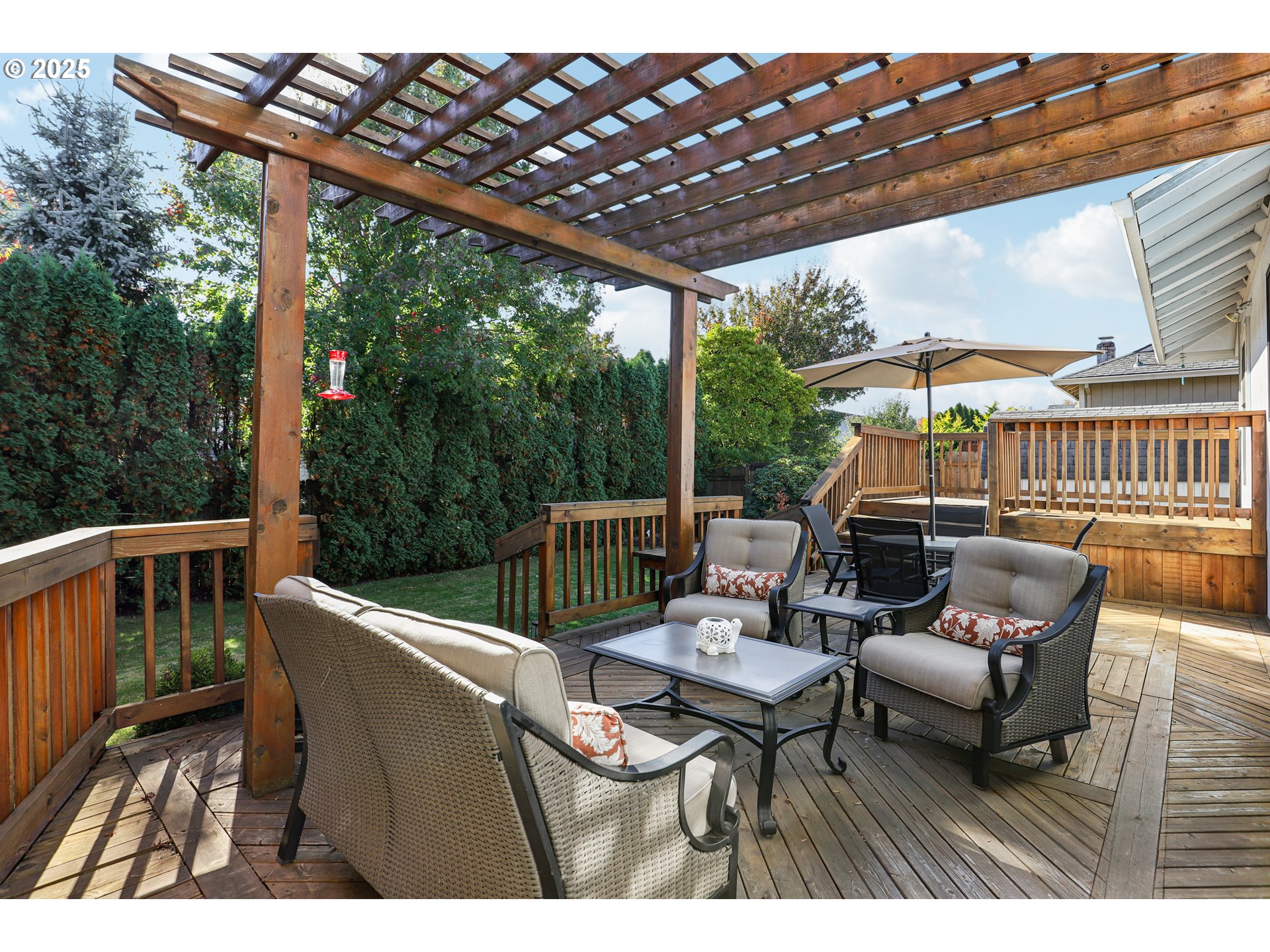 3786 Southwest 8th Street Gresham, OR 97030 - Photo 35 of 43 a view of a patio with a dining table and chairs with wooden floor
