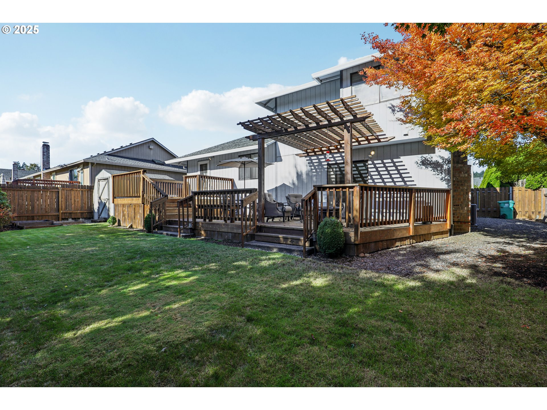 3786 Southwest 8th Street Gresham, OR 97030 - Photo 39 of 43 a view of a big house with a big yard and large trees