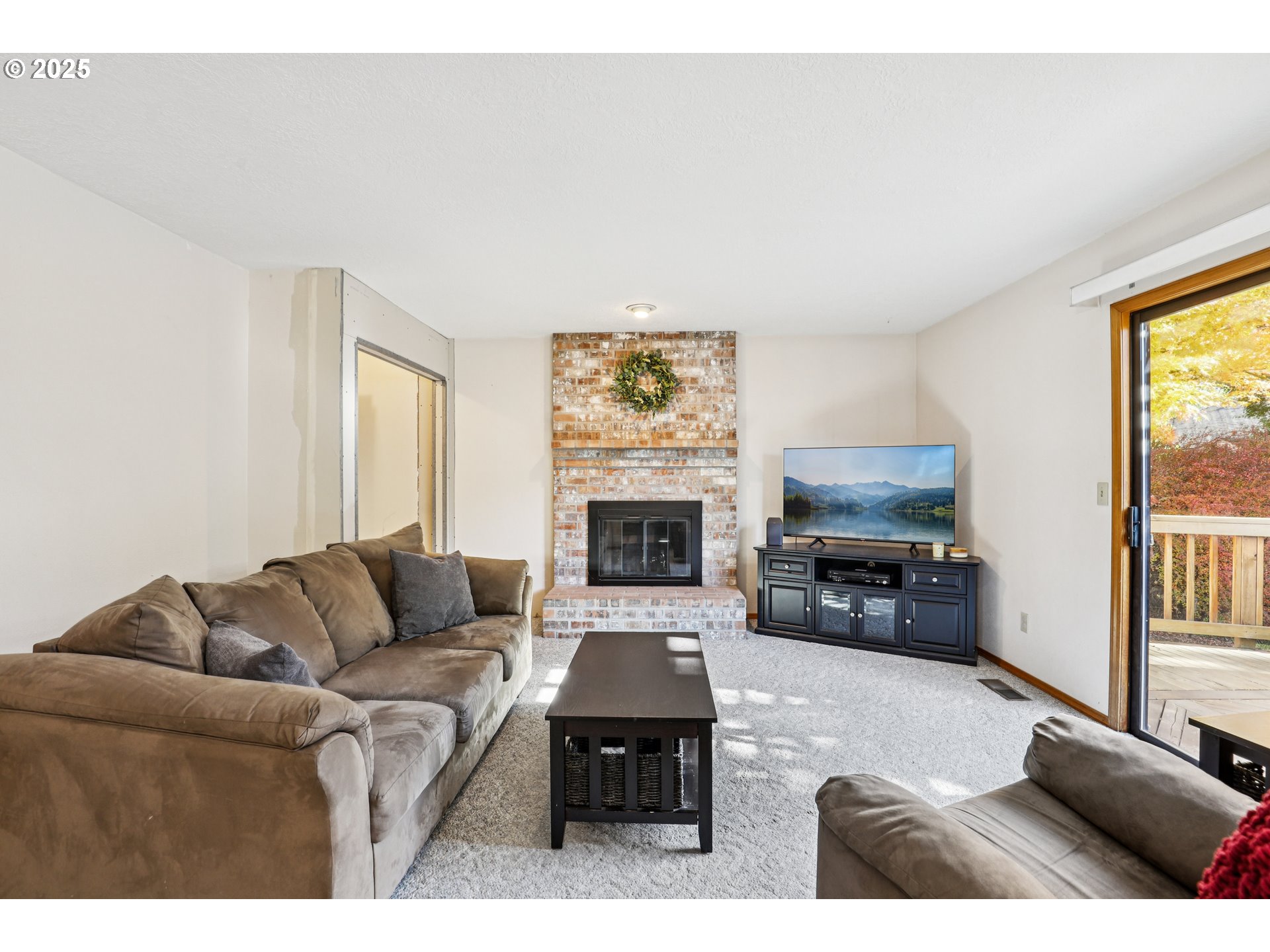 3786 Southwest 8th Street Gresham, OR 97030 - Photo 4 of 43 a living room with furniture a fireplace and a flat screen tv