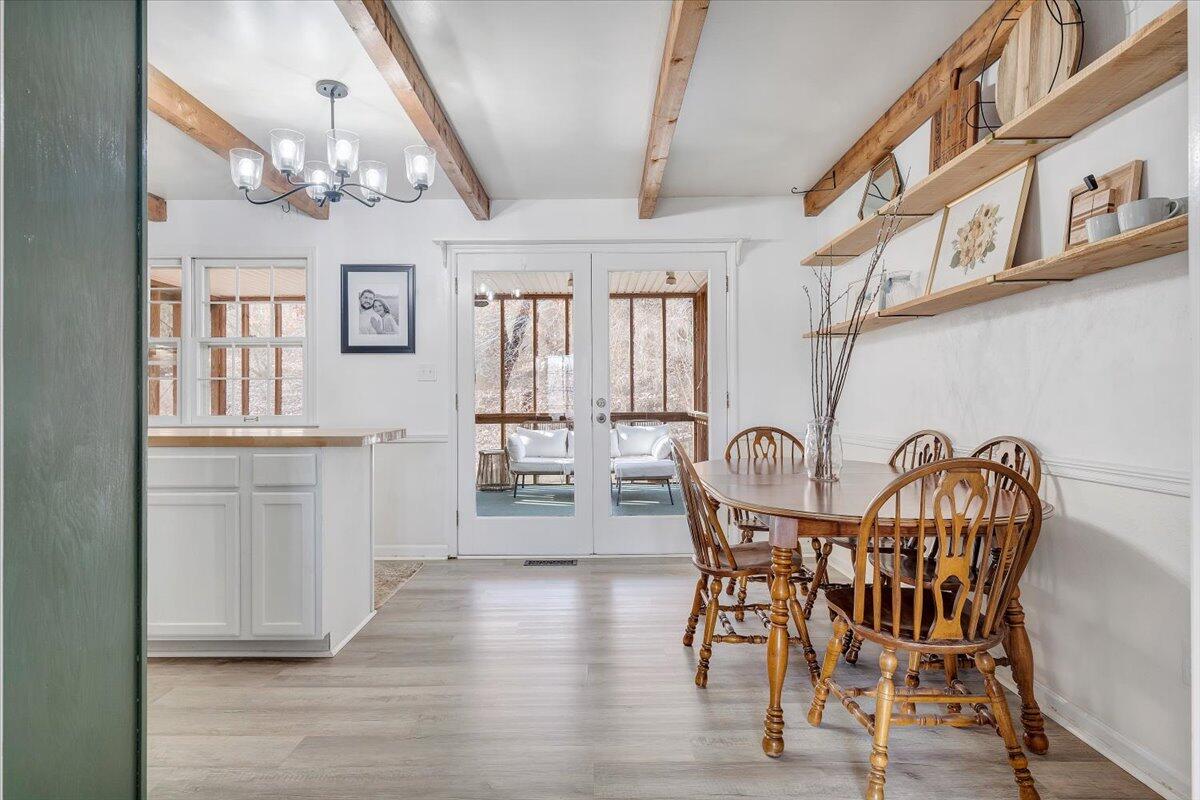 609 Lakeshore Terrace Road Hardy, VA 24101 - Photo 10 of 44 a view of a dining room with furniture a chandelier and wooden floor