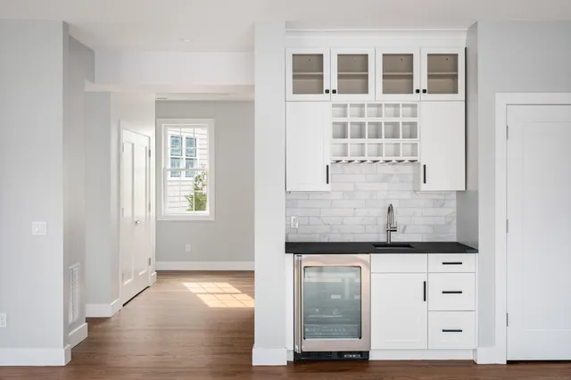 a view of a kitchen with granite countertop cabinets and wooden floor