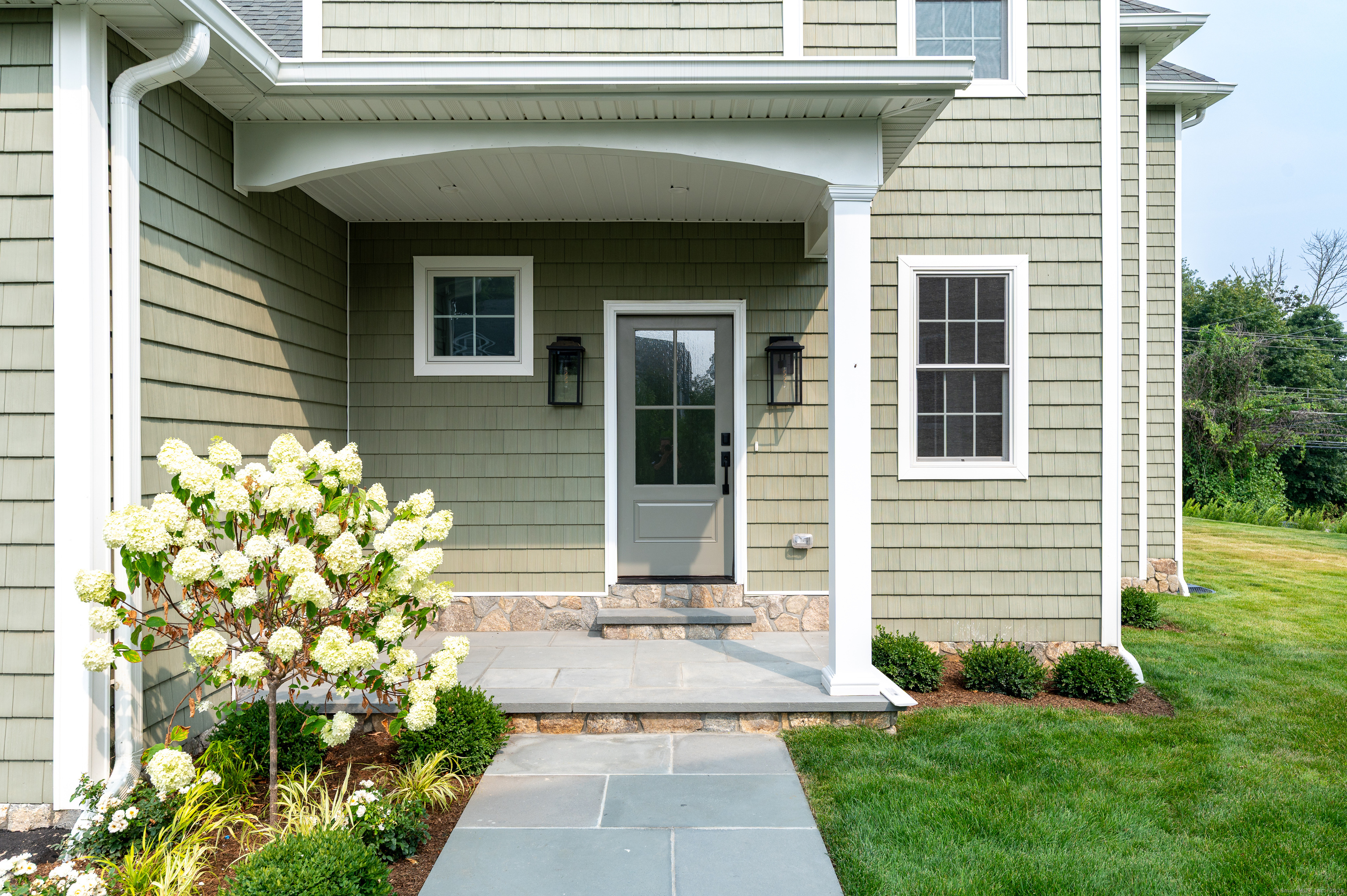 6 Walnut Ridge Court Stamford, CT 06905 - Photo 2 of 35 a front view of a house with garden