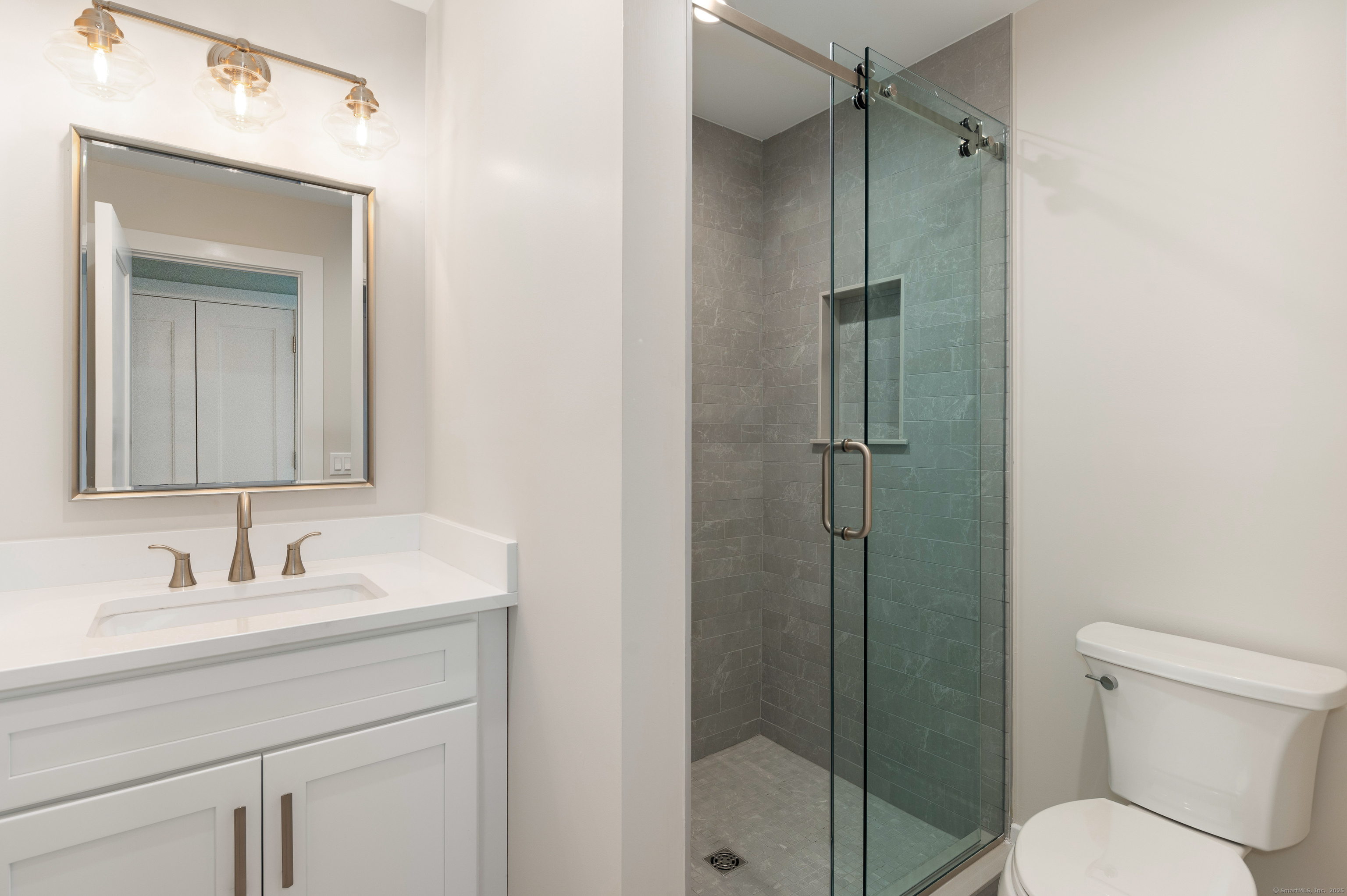6 Walnut Ridge Court Stamford, CT 06905 - Photo 26 of 35 a bathroom with a shower sink vanity mirror and toilet