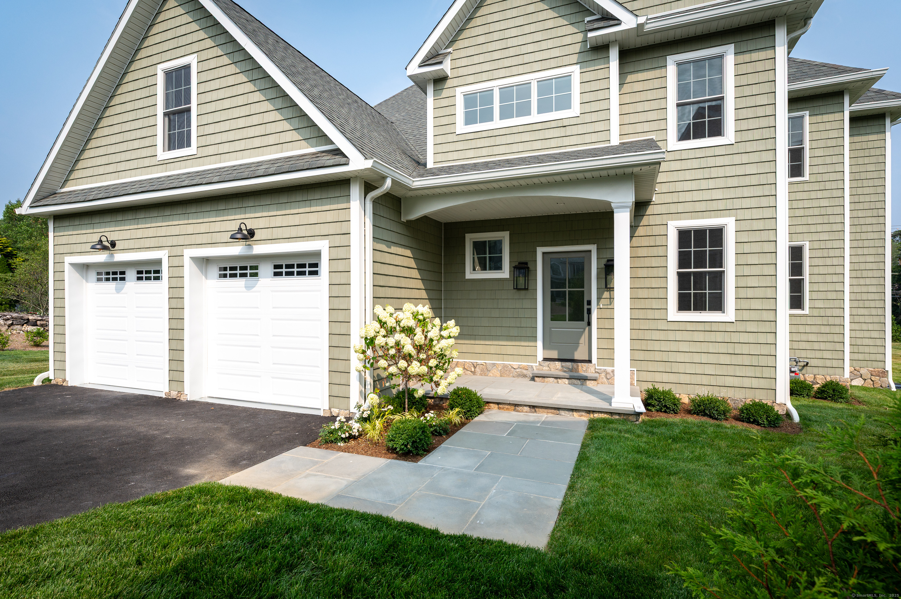 6 Walnut Ridge Court Stamford, CT 06905 - Photo 3 of 35 a front view of a house with a yard and garage