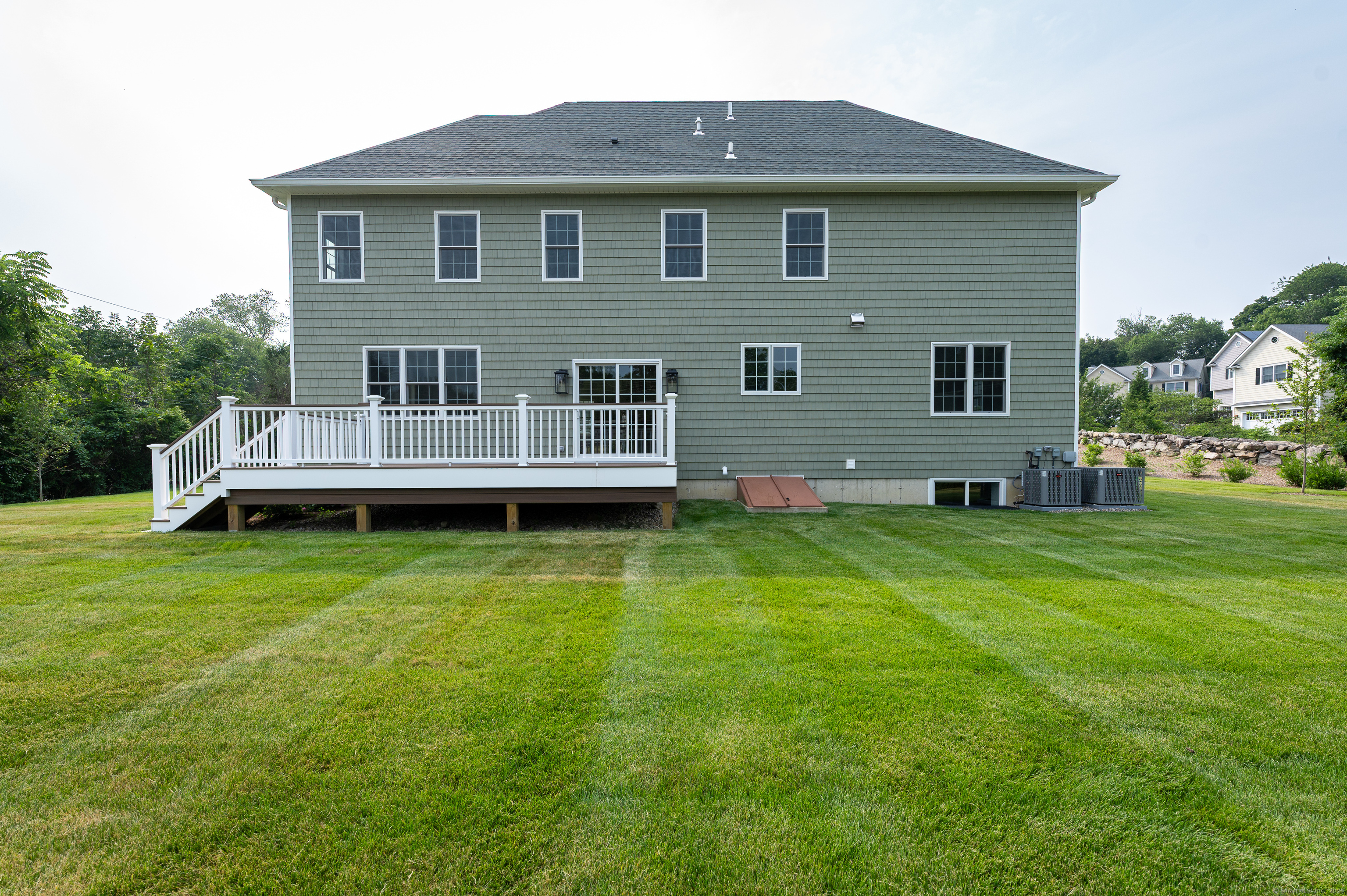 6 Walnut Ridge Court Stamford, CT 06905 - Photo 4 of 35 a front view of a house with a garden