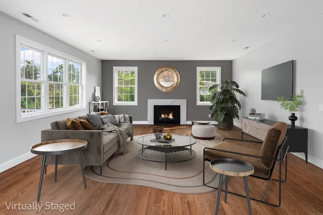 a living room with furniture a window and a fireplace