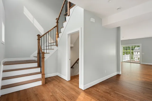 a view of entryway with wooden floor and stairs