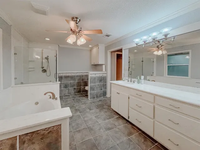 a bathroom with a sink a large mirror and a bathtub