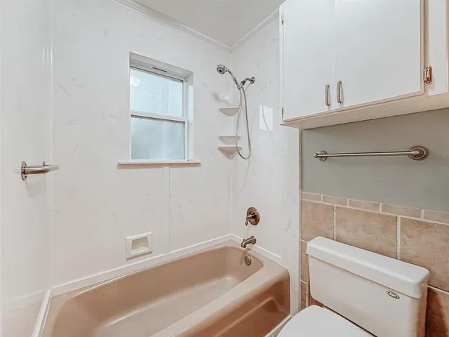 a bathroom with a bathtub and toilet