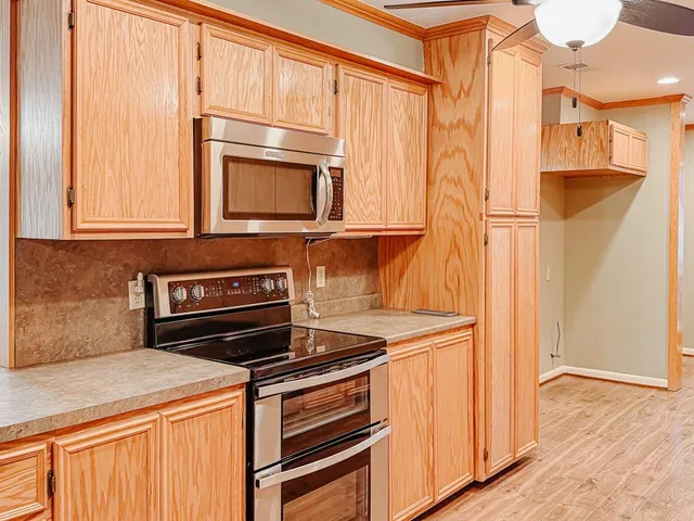 a kitchen with wooden cabinets and a stove top oven