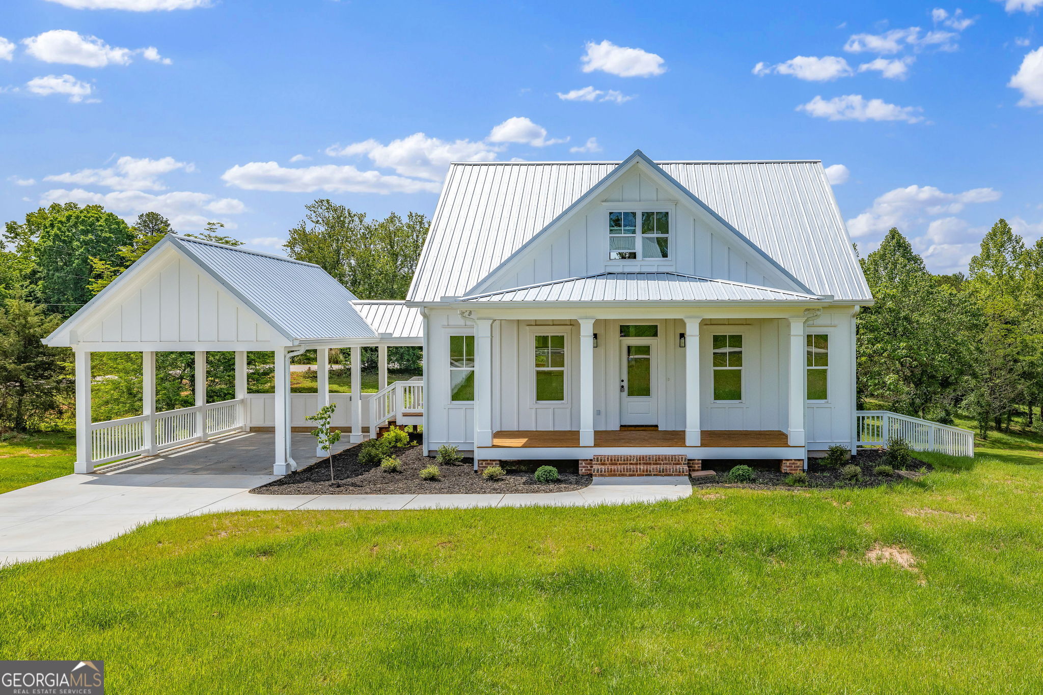 a front view of a house with a garden and patio