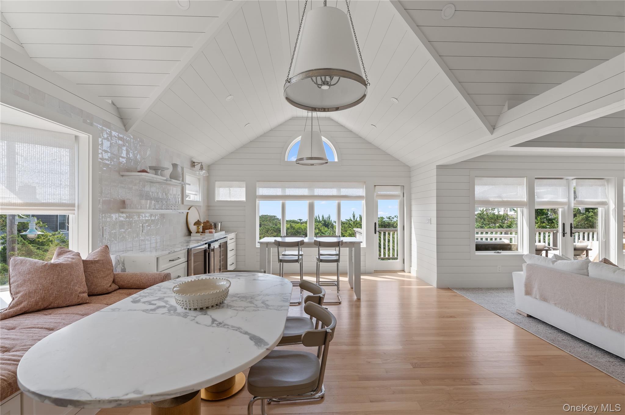 1005 Surf View Ocean Beach, NY 11770 - Photo 13 of 43 a view of a dining room with furniture a chandelier and wooden floor