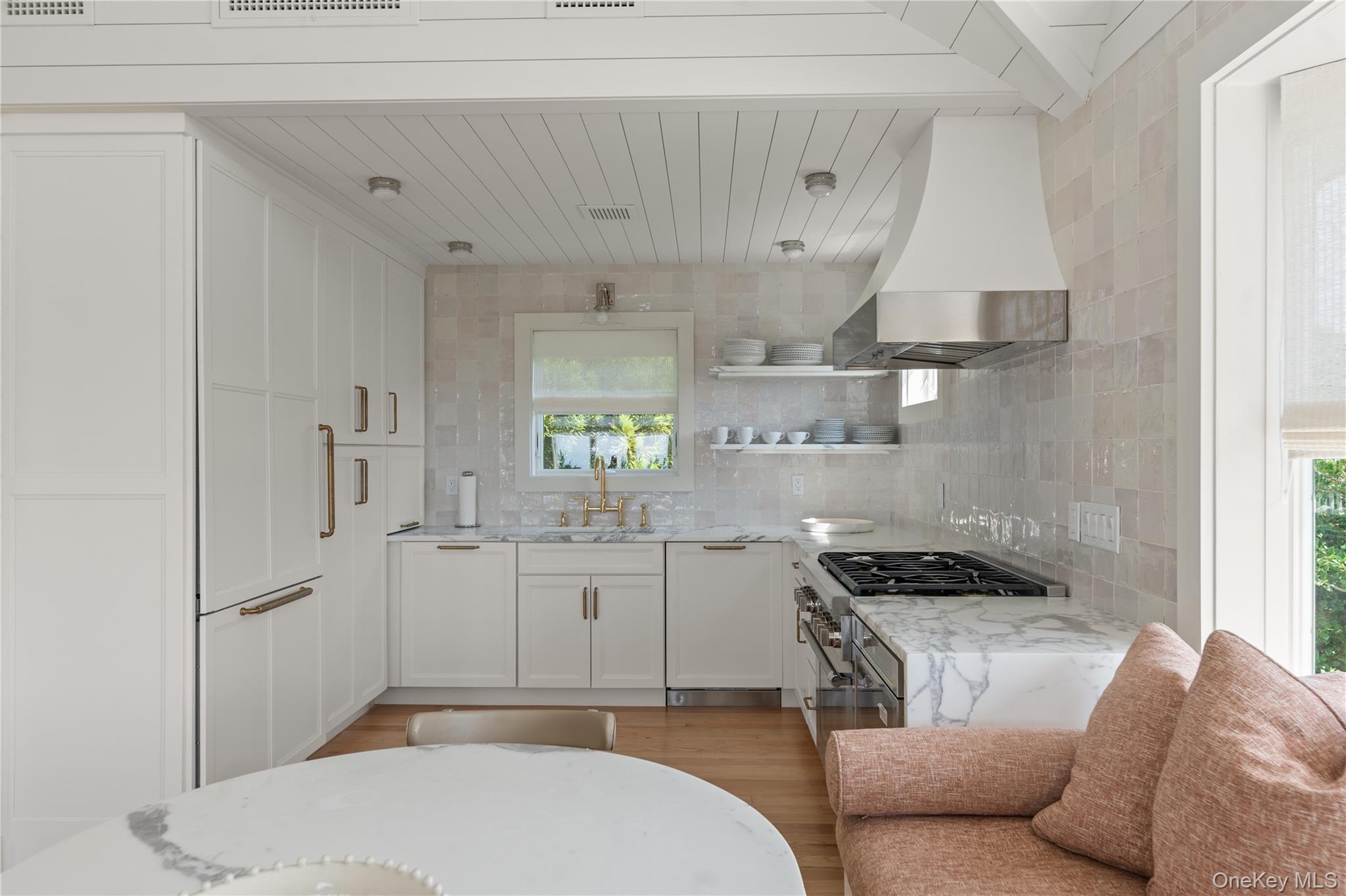 1005 Surf View Ocean Beach, NY 11770 - Photo 15 of 43 a kitchen with stainless steel appliances granite countertop a sink a stove a refrigerator and cabinets