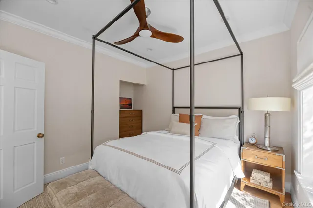 a bedroom with a bed and a mirror