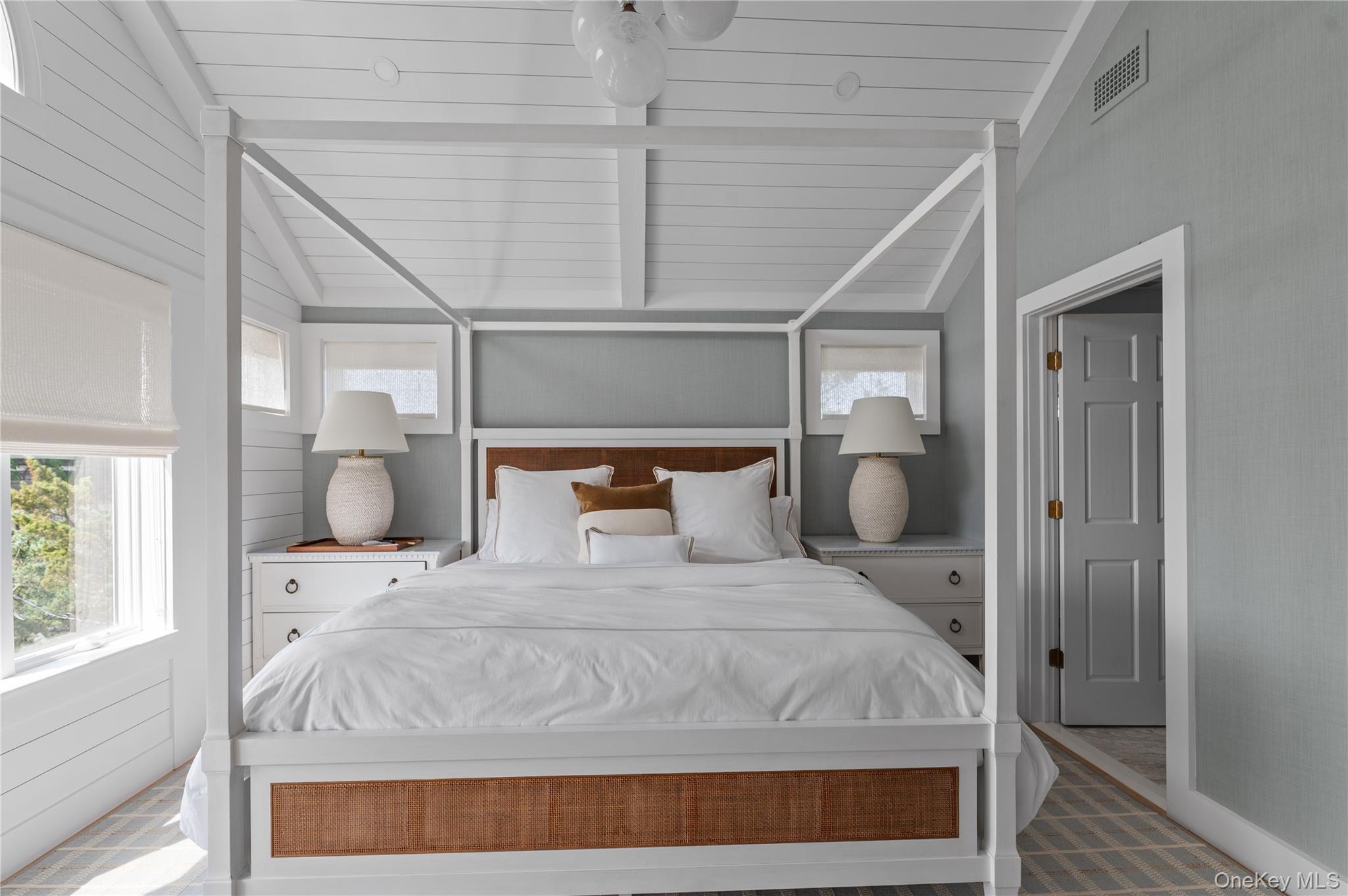 1005 Surf View Ocean Beach, NY 11770 - Photo 18 of 43 a large bed sitting in a bedroom next to a window