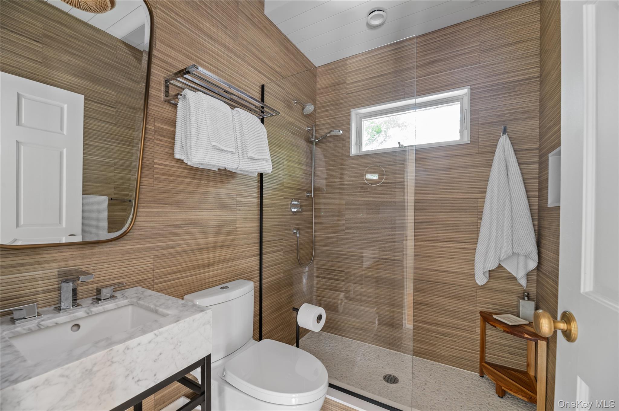 1005 Surf View Ocean Beach, NY 11770 - Photo 31 of 43 a bathroom with a sink a toilet and shower