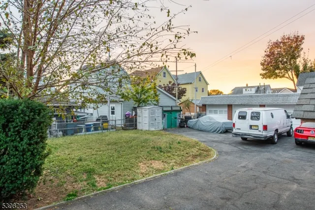 a white house that has a tree in front of it