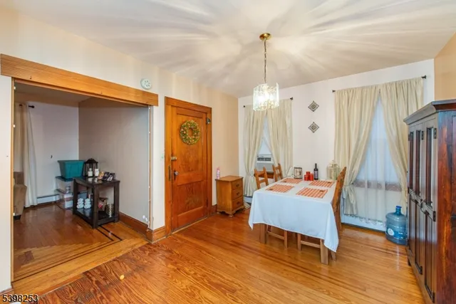 a living room with furniture a table and wooden floor