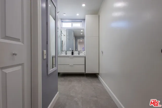 a view of a bathroom with sink mirror and window