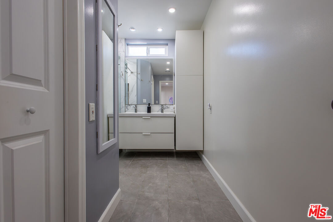 5123 Noble Avenue Sherman Oaks, CA 91403 - Photo 11 of 22 a view of a bathroom with sink mirror and window