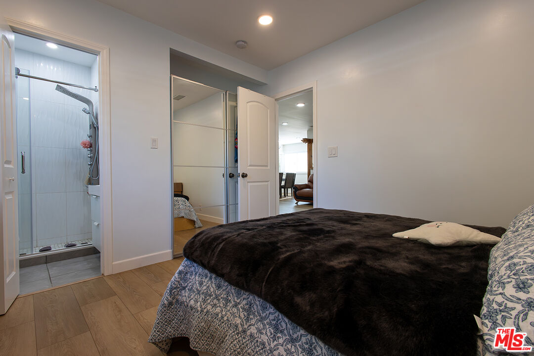 5123 Noble Avenue Sherman Oaks, CA 91403 - Photo 14 of 22 a bedroom with a bed and a mirror