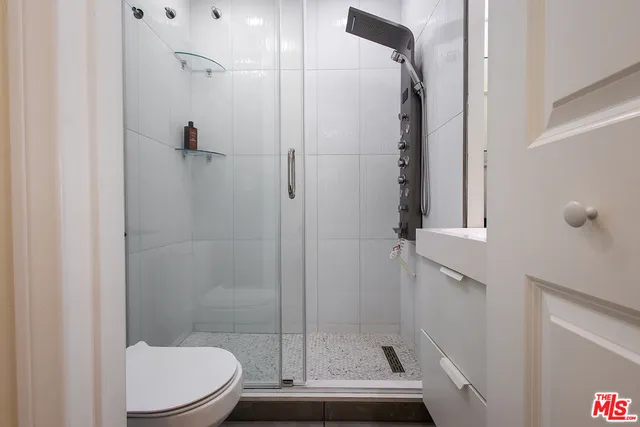 a bathroom with a shower and toilet