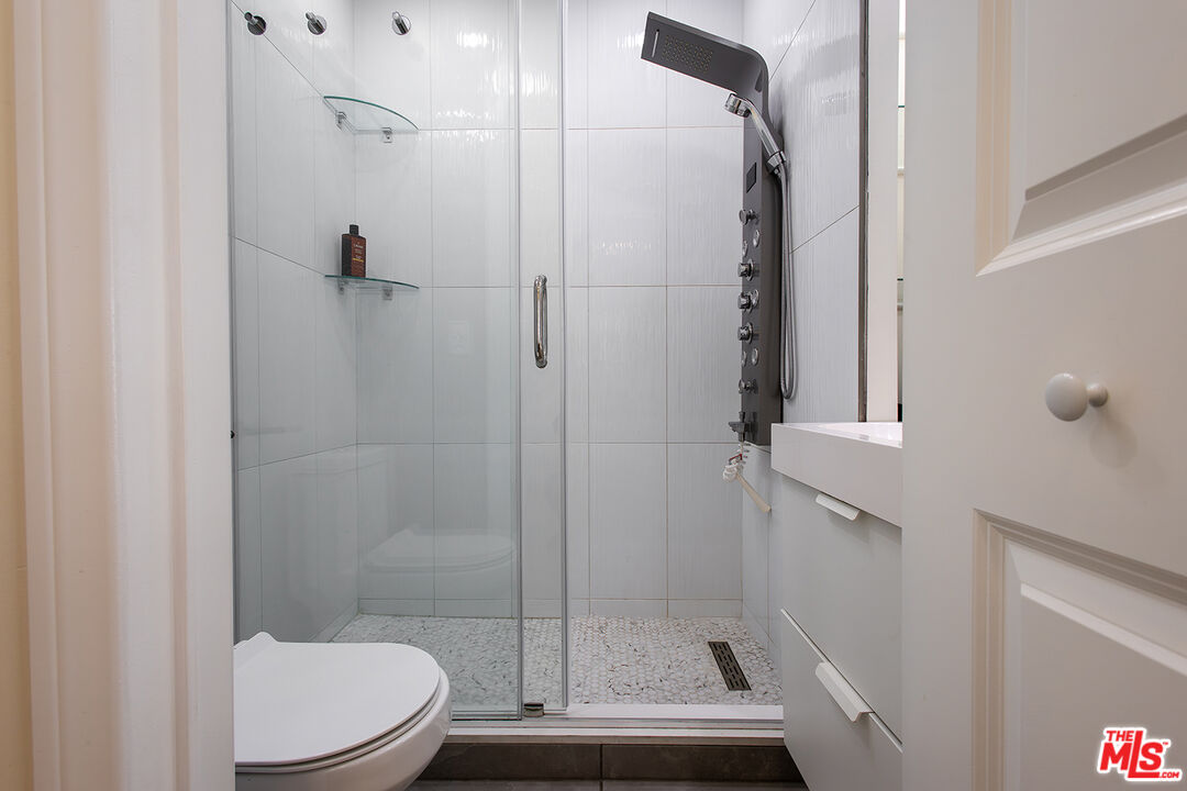 5123 Noble Avenue Sherman Oaks, CA 91403 - Photo 17 of 22 a bathroom with a shower and toilet