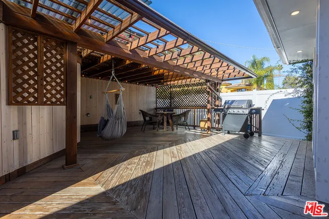 a view of a patio with table and chairs with wooden floor
