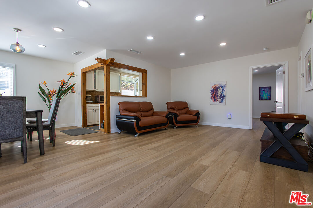 5123 Noble Avenue Sherman Oaks, CA 91403 - Photo 2 of 22 a living room with furniture and a wooden floor