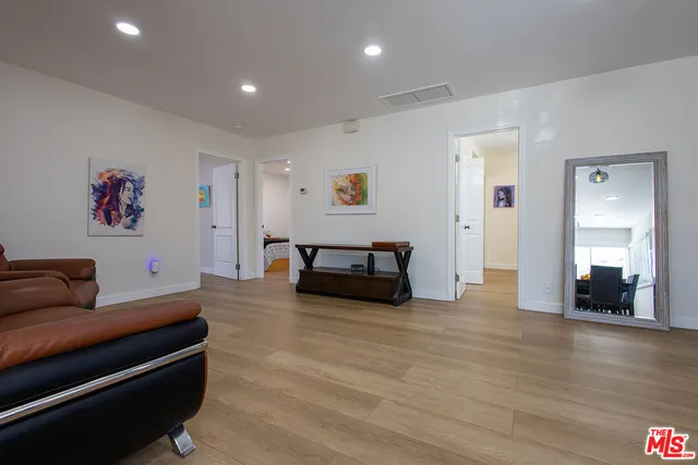 a living room with furniture and kitchen view