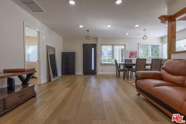 a living room with furniture and a dining table