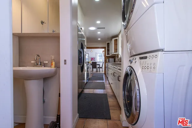 a bathroom with a sink a washer and dryer
