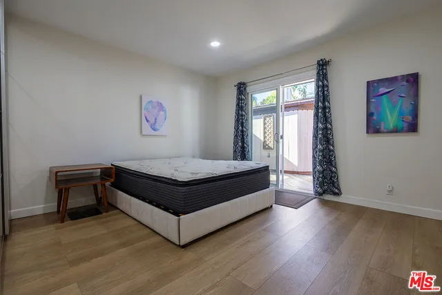 a bed room with a bed and a painting