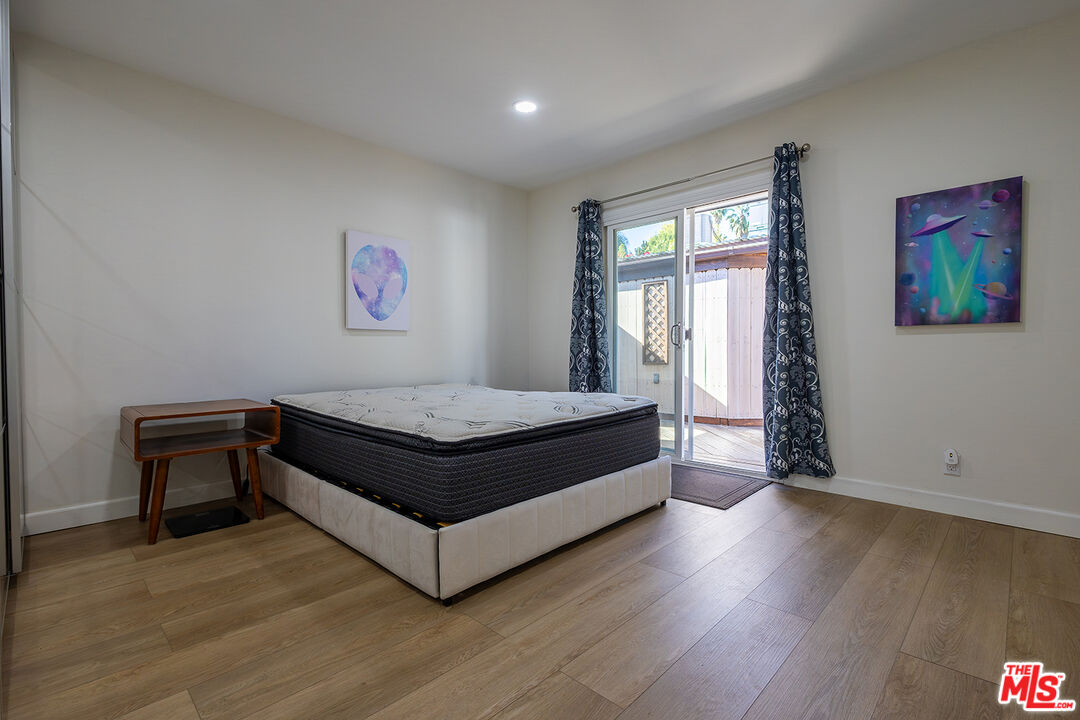 5123 Noble Avenue Sherman Oaks, CA 91403 - Photo 9 of 22 a bed room with a bed and a painting