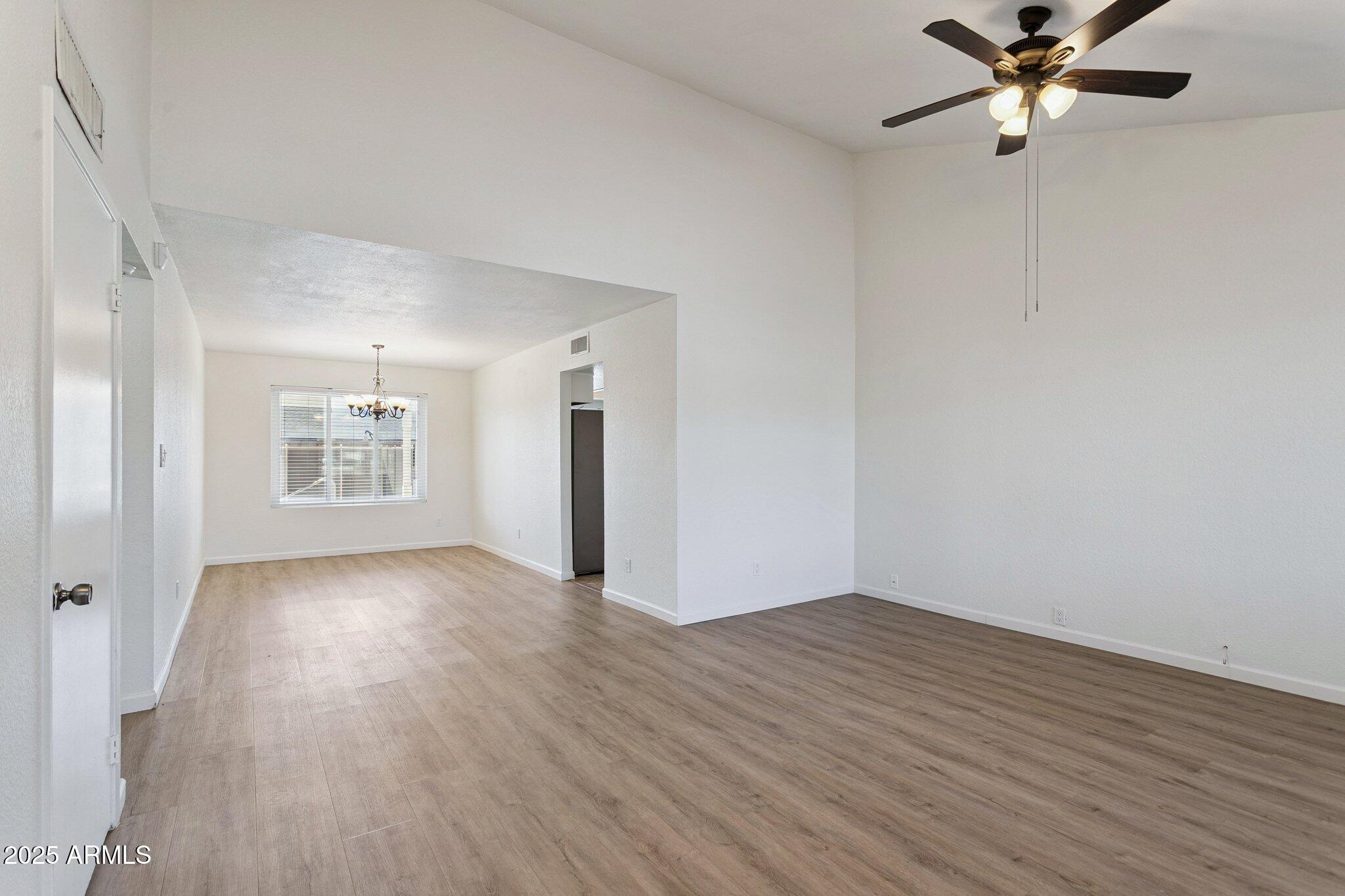 4915 East Everett Drive Scottsdale, AZ 85254 - Photo 12 of 39 an empty room with wooden floor a ceiling fan and closet