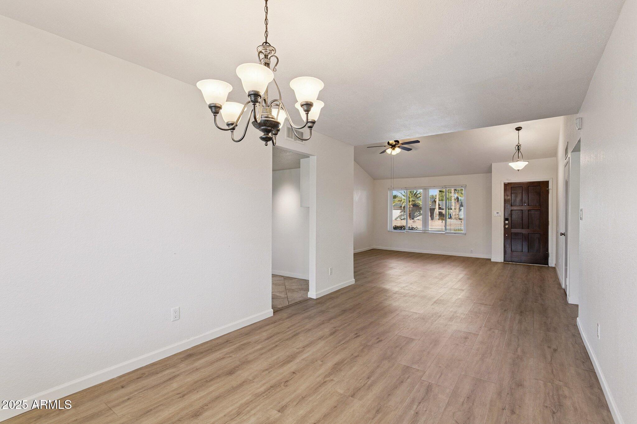 4915 East Everett Drive Scottsdale, AZ 85254 - Photo 13 of 39 a view of an empty room with wooden floor and a window