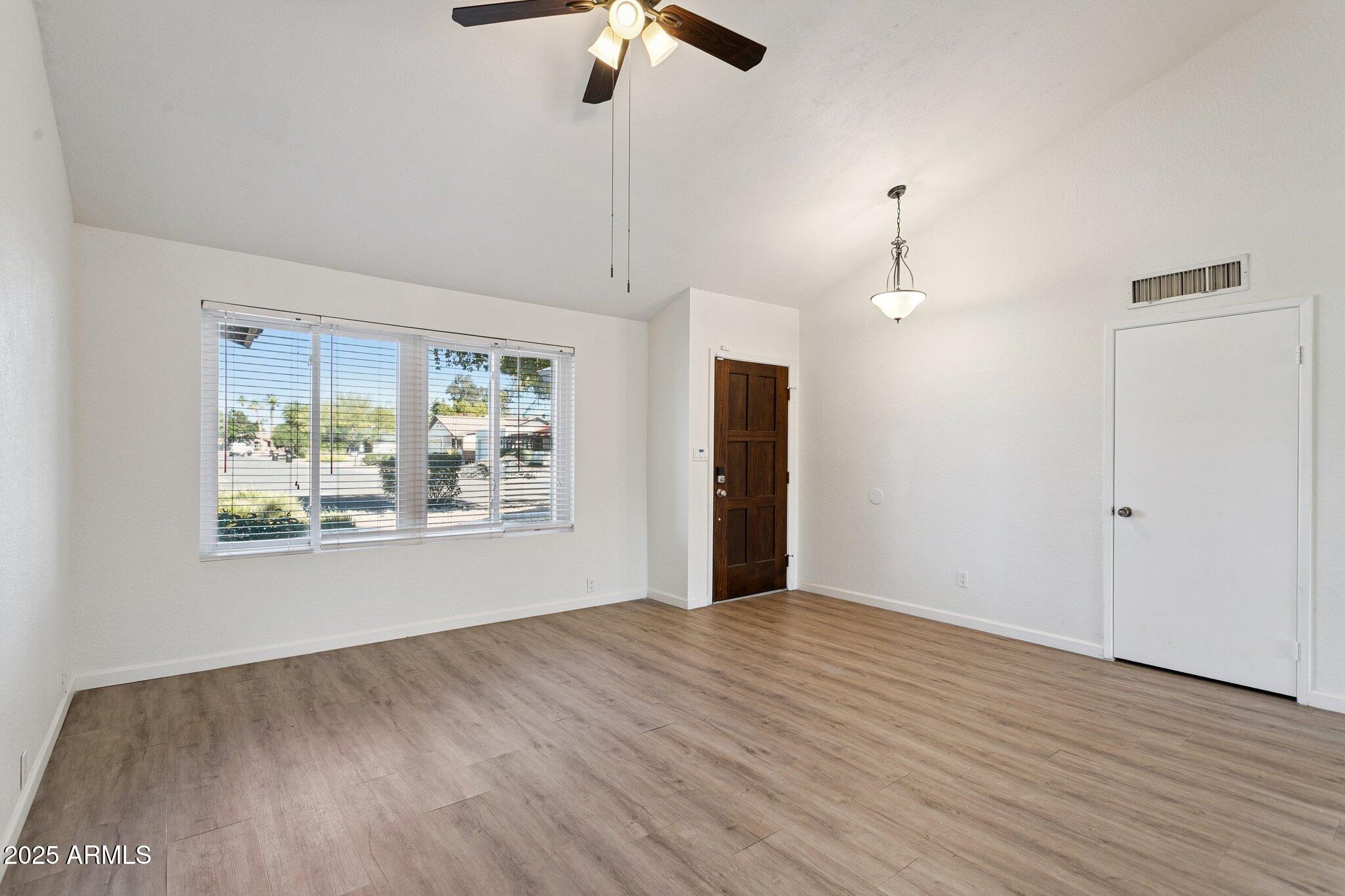4915 East Everett Drive Scottsdale, AZ 85254 - Photo 16 of 39 a view of an empty room with wooden floor and a window