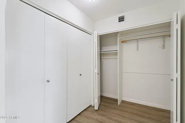 a view of a room with wooden floor