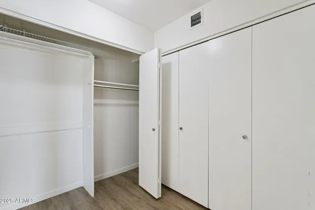 a view of closet area with wooden floor
