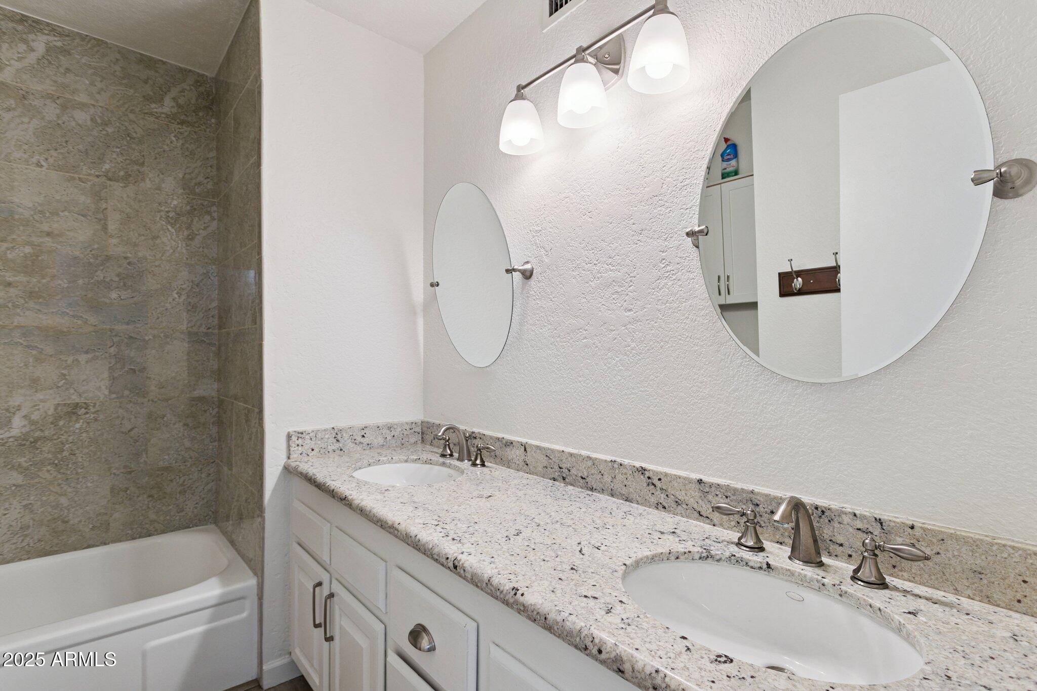 4915 East Everett Drive Scottsdale, AZ 85254 - Photo 29 of 39 a bathroom with a granite countertop sink mirror toilet and bathtub